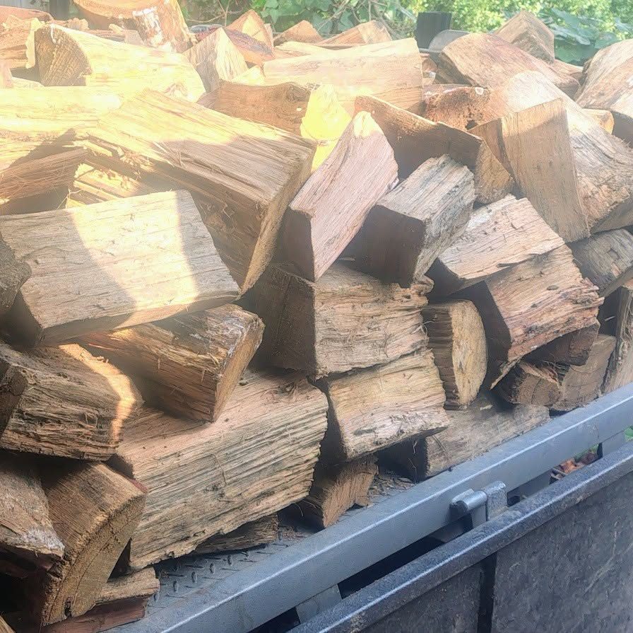 Split hardwood stacked on a trailer